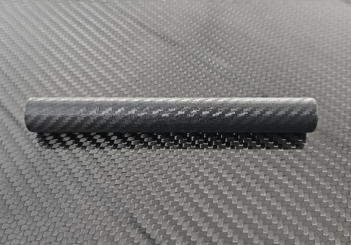 A side-by-side comparison of a 3D printed part, one raw and the other infused with carbon fiber for a sleek finish.